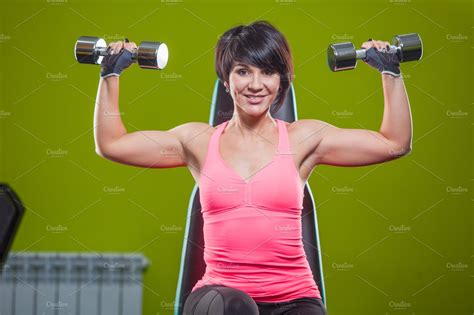 Gym Woman Strength Training Lifting Dumbbell Weights In Shoulder Press