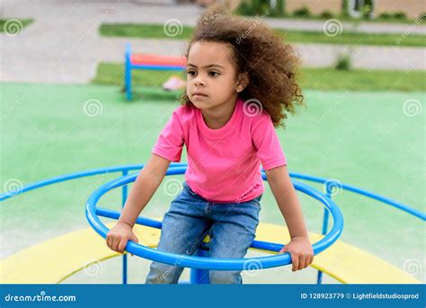 Curly African American Little Child Riding On Carousel Stock Image