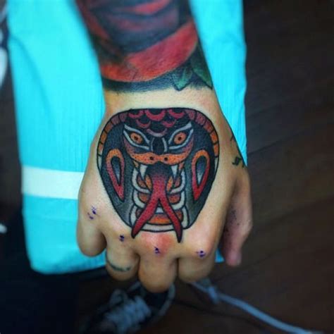 A Person With A Tattoo On Their Hand