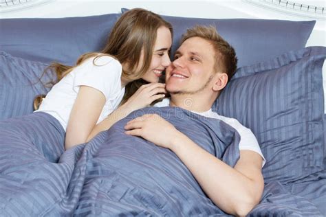 Beautiful Awakened Loving Couple In Bed In The Morning Young Adult Heterosexual Couple Lying On