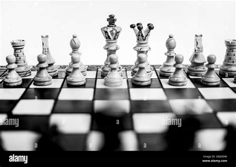 A Grayscale Shot Of A Chessboard With A Full Set Of Chess Pieces