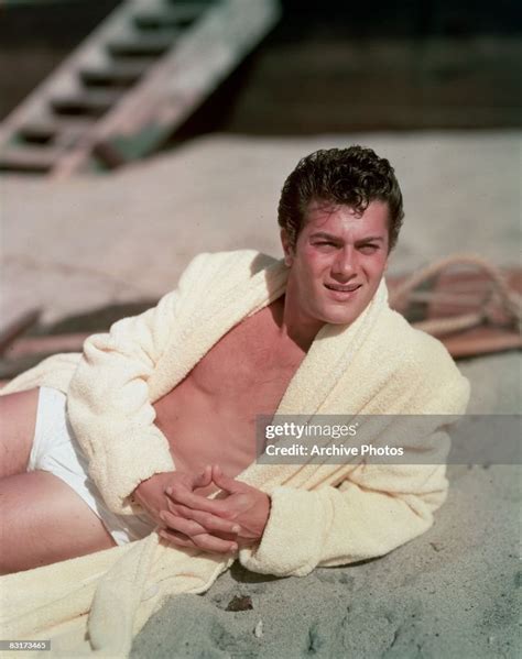 American Actor Tony Curtis Reclines On The Beach In A Terry Robe And News Photo Getty Images