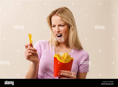Furious Beautiful Girl Posing With French Fries Isolated Over White