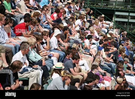 Crowds Of Spectators Watching A Tennis Match At Wimbledon Stock Photo