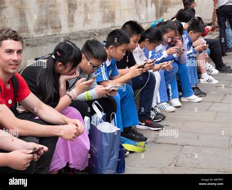 Children Young People Looking At Phone Looking At Smartphone