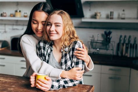 Free Photo Lesbian Couple Hugging In Kitchen