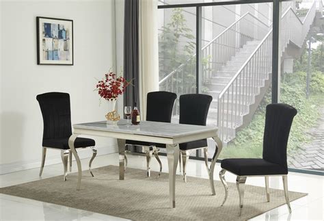 A round marble tabletop evokes a sense of. White marble dining table and 4 black velvet chairs ...