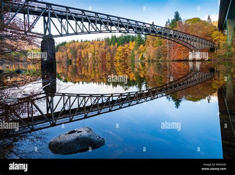 Spectacular Late Autumn Tree Colours And Bridge Is Reflected In The