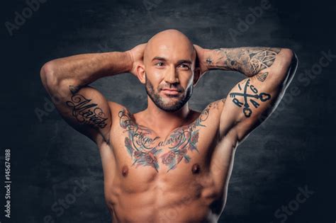Shaved Head Shirtless Athletic Male With Tattoos On His Torso And Arms