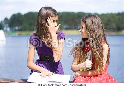 Two Girls Talking Secrets Canstock