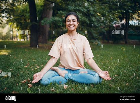 Indian Woman Doing Yoga And Meditation In Lotus Asana Pose In Outdoor