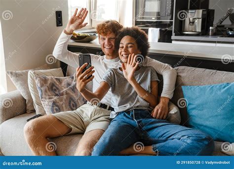 Young Happy Interracial Couple Holding Video Conference With Phone