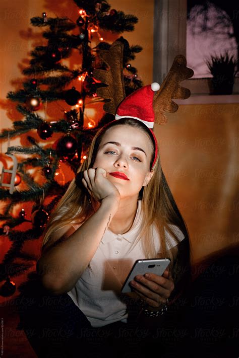 Young Pensive Girl With Phone In Christmas Del Colaborador De Stocksy Danil Nevsky Stocksy