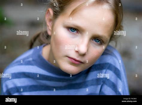 Sad Little Girl Is Looking With Serious Face At Camera Stock Photo Alamy