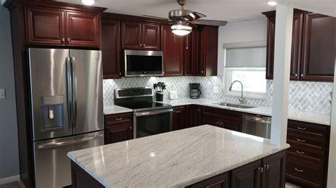 Rich Cherry Raised Panel Cabinetry By Kith Kitchens Is Complemented By White And Gray Marble