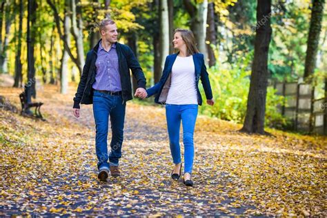 Young Couple Walking In Park — Stock Photo © Gbh007 50531649