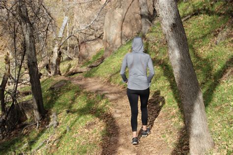 Free Stock Photo Of Woman In Hoodie And Yoga Pants Walking Through Nature