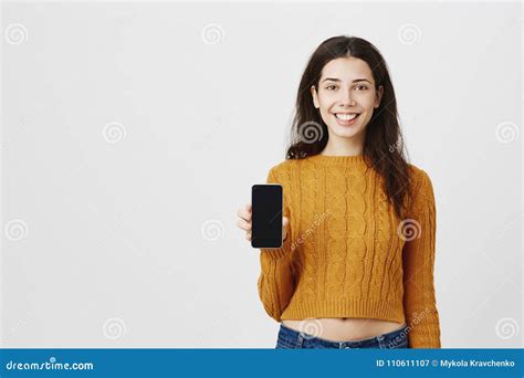 Portrait Of Cute Attractive Smiling Woman Advertising Smartphone