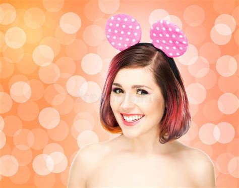 Beautiful Young Smiling Woman In Mickey Mouse Ears On Bubble Background