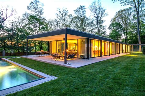 photo 3 of 10 in a renovated midcentury glass and steel house in new… modern glass house