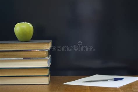 Libros De Escuela Con La Manzana Verde En El Escritorio Foto De