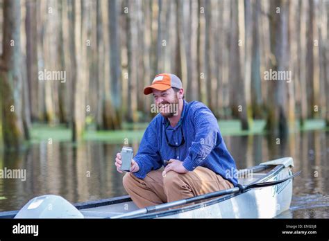 Caucasian Man Drinking Beer In Canoe On River Stock Photo Alamy
