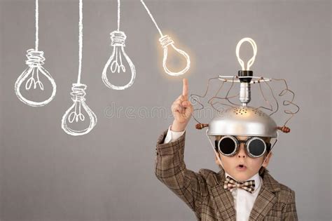 Smart Child Wearing Funny Helmet With Illuminated Lightbulb Stock Image