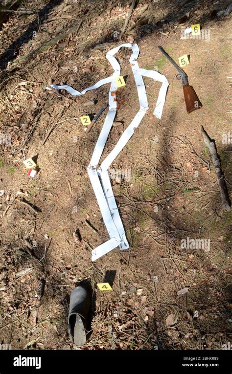 Crime Scene Setup With Body Outline And Numbered Evidence Markers In