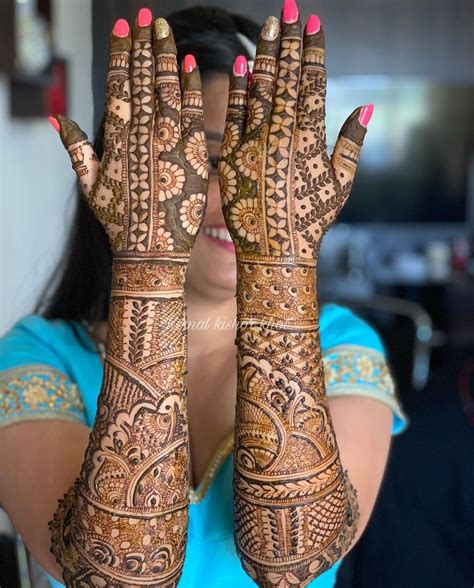 A Woman Holding Her Hands Up With Henna On It