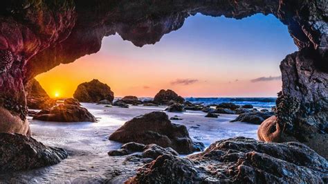 Epic Sunset From A Sea Cave 4k Ultrahd Wallpaper Backiee