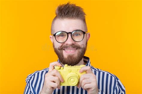 Cute Young Male Photographer With A Mustache And Beard Is Photographing