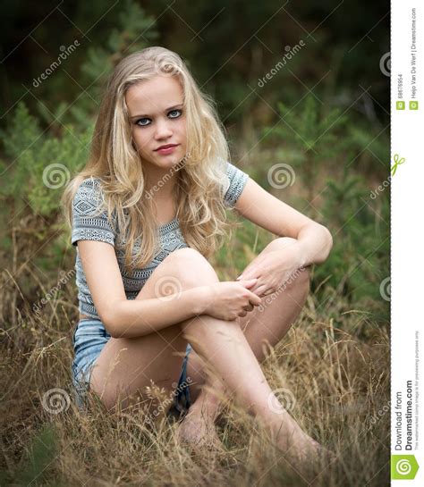 Pretty Blond Teenager Sitting In The Grass Stock Photo Image