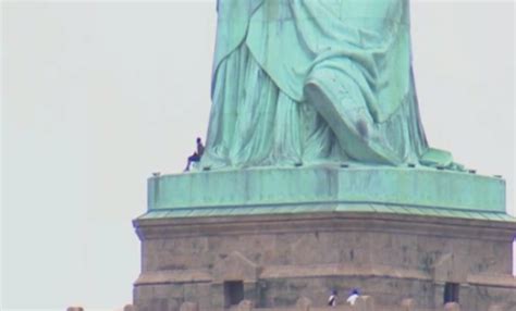 Live Person Climbing Statue Of Liberty In New York