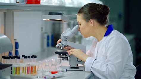 Female Scientist With Microscope In Lab Stock Footage Sbv