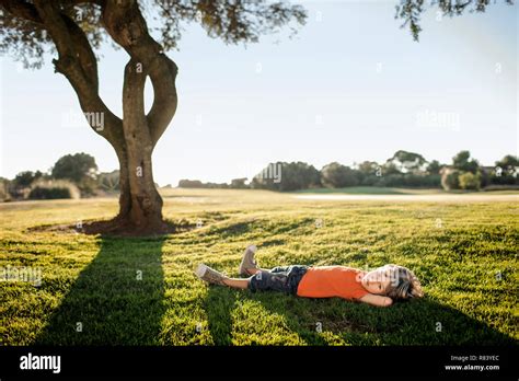 Young Boy Peacefully Lying In A Field Stock Photo Alamy