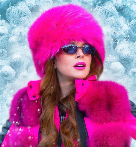 A Woman Wearing Sunglasses And A Pink Fur Hat