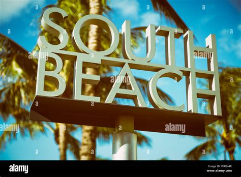 Scenic Sunlit View Of The Entrance To South Beach Sign With A Tropical