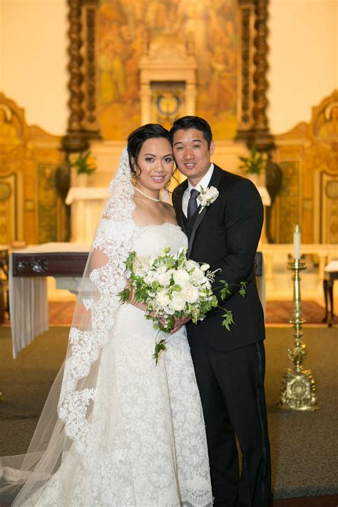 Bride And Groom Pose In Catholic Church