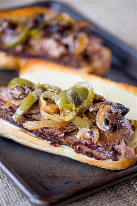 In your slow cooker add the beef, the beef broth, the french onion soup, worcestershire sauce, and the beer. Slow Cooker Philly Cheese Steak Sandwiches | AllFreeCopycatRecipes.com