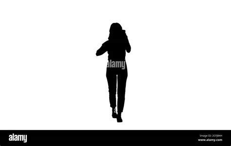 Silhouette Blonde Walking And Preening Looking In The Phone Stock Photo