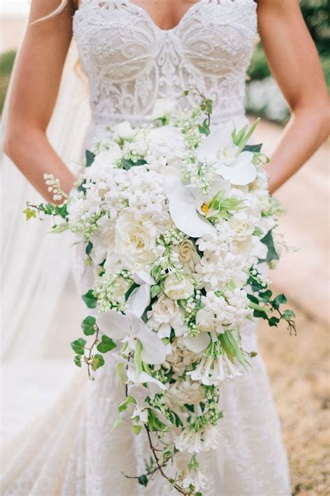 Bride In Berta Wedding Dress Holding Cascade Bouquet Cascading With White Orchid Flowers