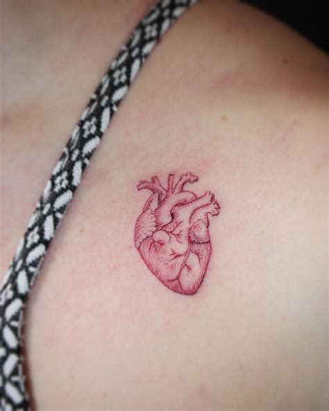 Red Ink Real Heart Tattoo On Women Left Front Shoulder