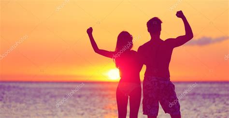 Happy Fitness People On Beach At Sunset Flexing — Stock Photo © Maridav