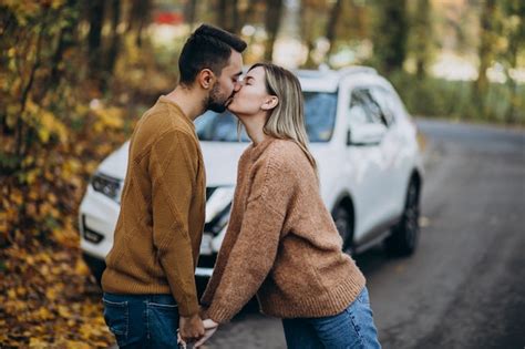 Free Photo Couple In Forest Kissing In Front Of A Car