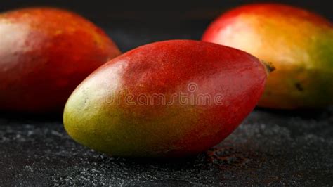 Fresh Mango Tropical Fruit On Rustic Black Background Stock Photo