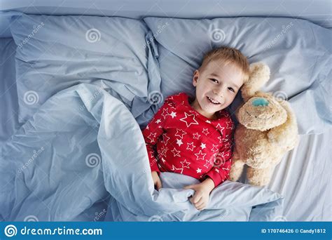 Sleepy Boy Lying In Bed With White Beddings Stock Photo Image Of
