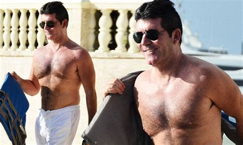 Simon Cowell Shows Off Toned Physique In White Shorts As He Jumps On A Jet Ski In Barbados