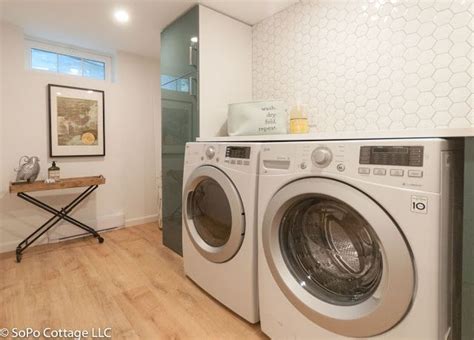 A Washer And Dryer In A Room With Wood Flooring On The Walls