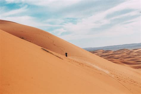 Photo Of Person Walking On Desert · Free Stock Photo