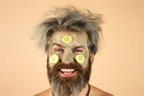 Happy Man With Funny Facial Mask With Cucumber Having Fun Procedure